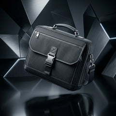 Premium black canvas laptop briefcase with a metallic AXIS buckle floating against a futuristic, dark geometric background with sharp metallic angles.