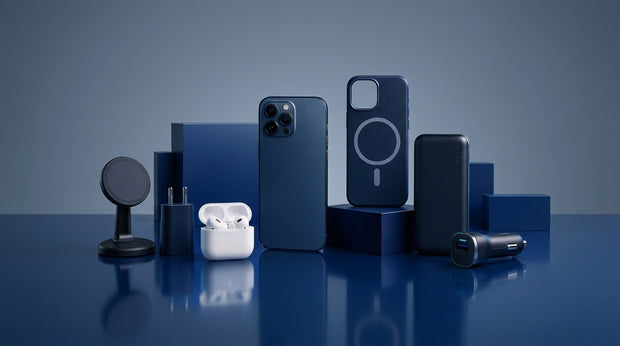 Premium mobile accessories collection featuring a blue iPhone, MagSafe case, wireless earbuds, power bank, and chargers
